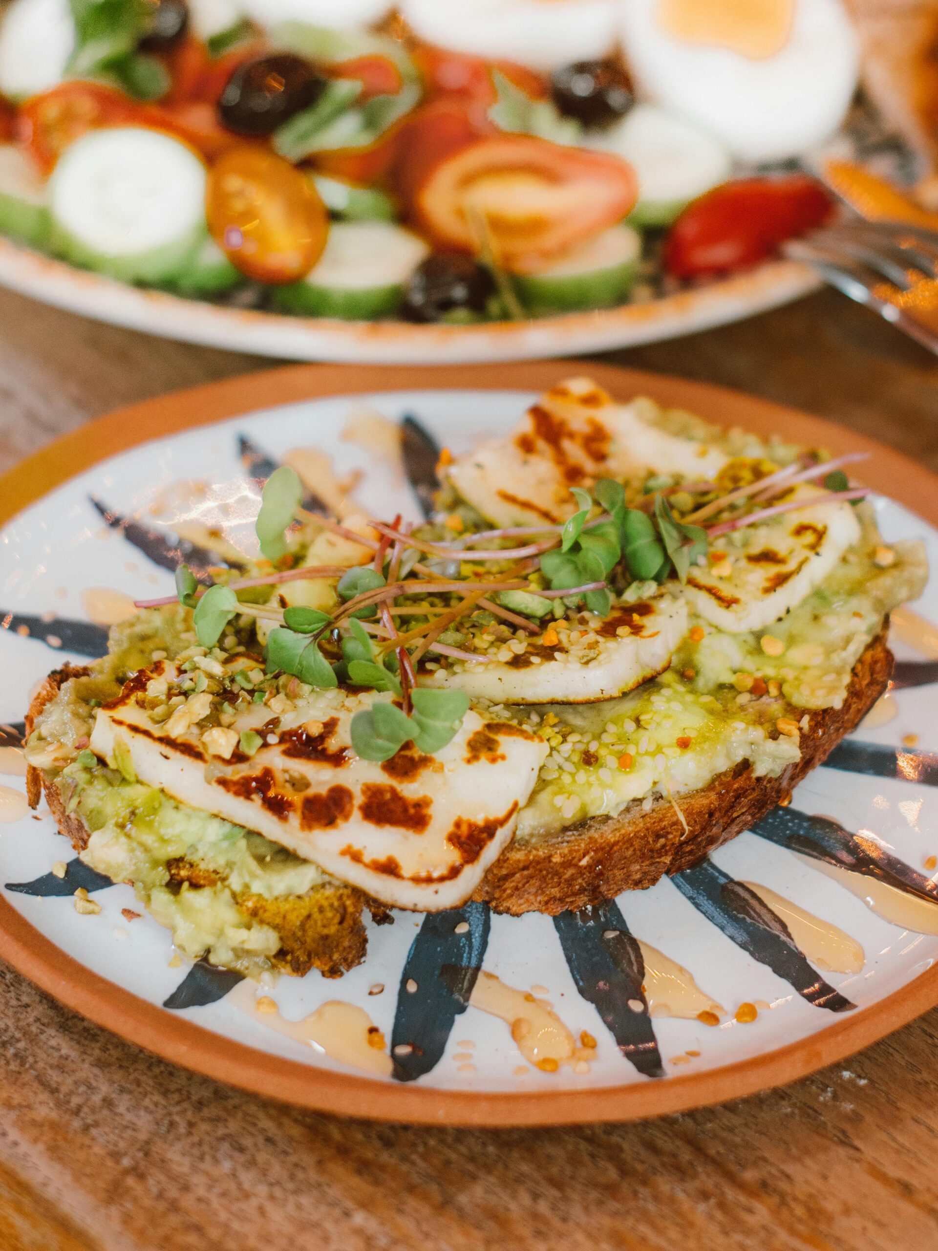 Savor a gourmet grilled halloumi and avocado toast, perfect for a healthy breakfast or brunch.